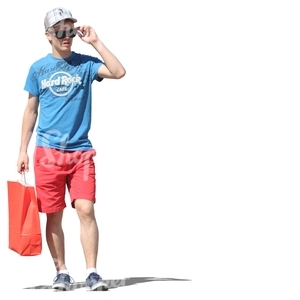 young man standing with a shopping bag in his hand