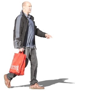 man walking with a bag in his hand