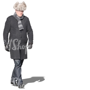 man with a fur hat walking in winter