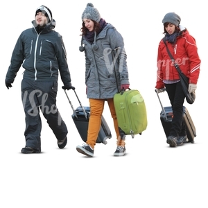 three people carrying suitcases in winter