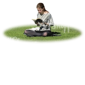 woman sitting on the grass and reading a book