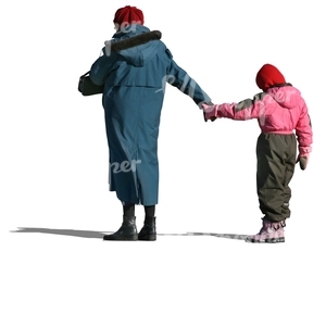 grandmother standing and holding a child by her hand