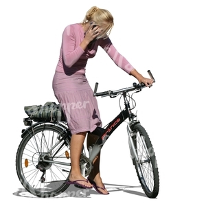 blond woman standing with a bike while on the phone