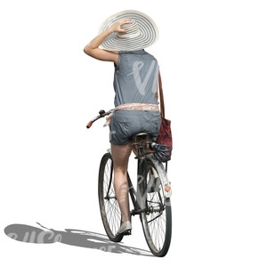 woman with a large hat riding a bike