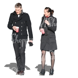 man and woman walking and drinking coffee