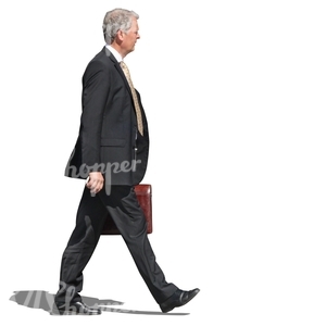 older businessman walking with a briefcase in his hand