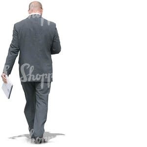 businessman walking with a notebokk in his hand