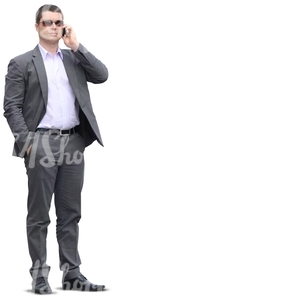 businessman in a grey suit talking on the phone