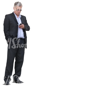 businessman standing and looking at his phone