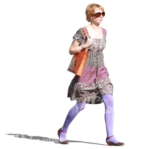 woman in a colorful dress walking hasttily