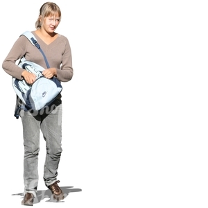 woman walking and looking in her backpack