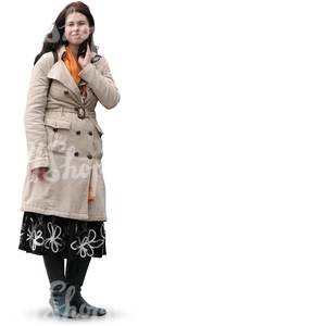 woman in a beige autumn coat standing