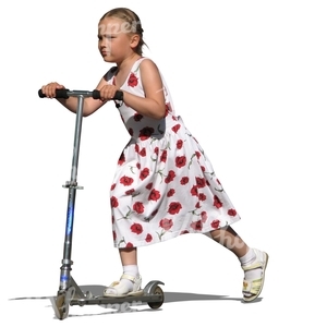 girl in a summer dress riding a scooter