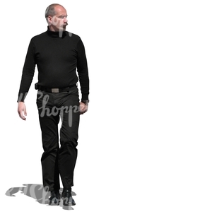 man in a black outfit walking