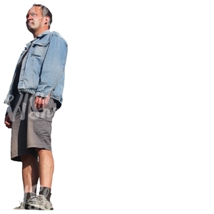 man in a denim jacket standing seen from below