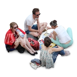 group of four sitting and having a picnic