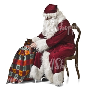 Santa Claus with a bag of gifts sitting on a chair