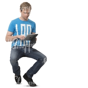 young man sitting and looking at his iPad