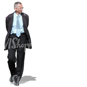 older businessman walking with a smile on his face