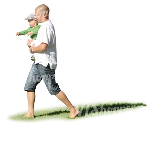 man walking on the grass hoding his son in his arms 