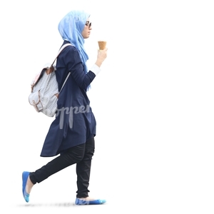 muslim woman walking and eating an icecream