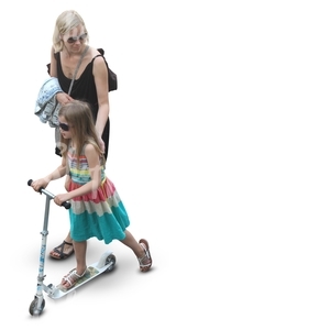 mother with her daughter whos riding a scooter