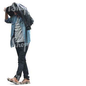 man walking and covering himself from the rain with his jacket