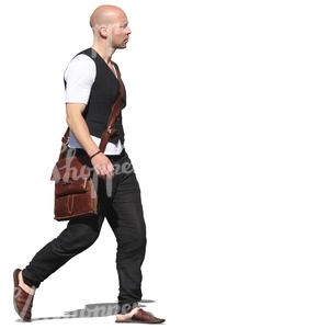 man in a black vest walking on the street