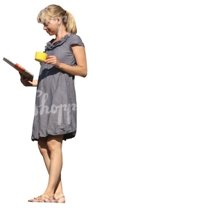 woman with a coffee cup standing on the balcony