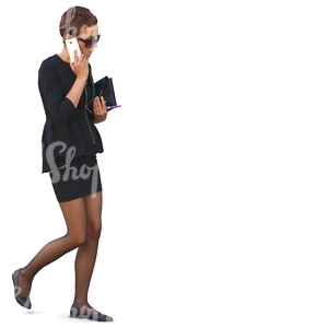 woman in a formal black costume walking and talking on a phone