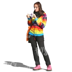 woman in a striped pullover standing and eating icecream