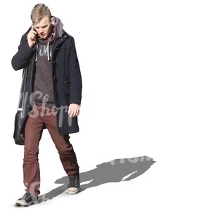 man in a black autumn coat walking and talking on the phone