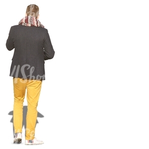 man with a big scarf and yellow trousers seen from behind