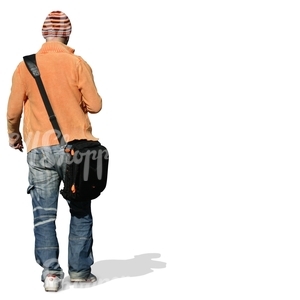 young man with a striped beanie walking