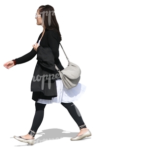 young woman in black and white clothes walking