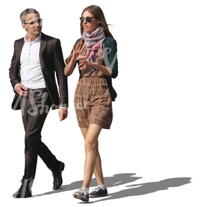 man and woman walking while having a conversation