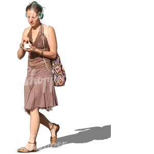 woman with headphones walking and eating icecream