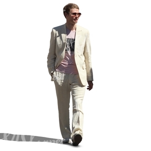 man in a white suit walking and smiling