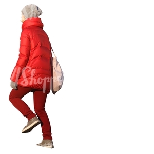 woman in a red winter coat walking up the stairs