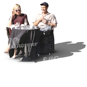 man and a woman sitting in a street cafe