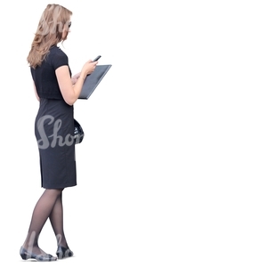 businesswoman in a black dress looking at her phone