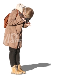 woman in a winter coat taking a picture