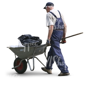 elderly man pushing a wheelbarrow