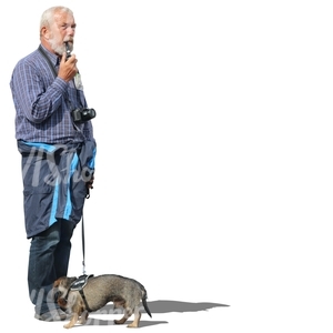 elderly man with a dog standing and smoking