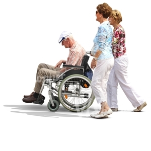 two women pushing a man in a wheelchair