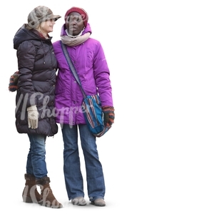 two women in winter clothes standing and talking