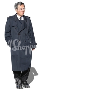 middle-aged asian businessman in a coat walking