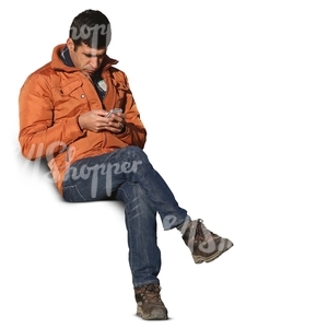 man sitting and looking at his smartphone