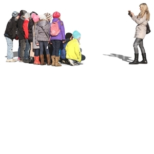 woman taking a picture of a group of children