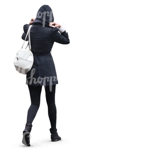 woman in black hooded coat walking int the rain